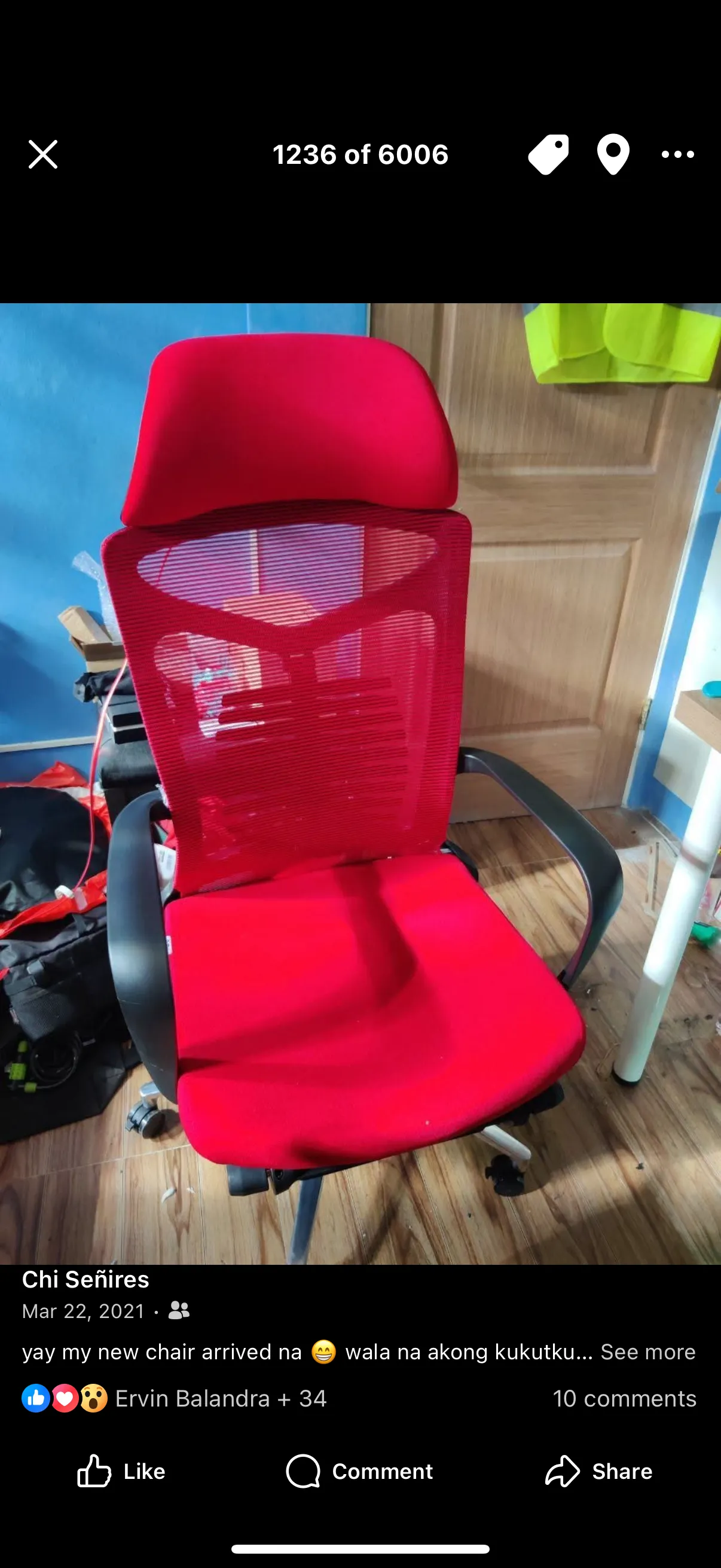 Screenshot of Chi’s Facebook post on March 22, 2021 of a photo, which is the 1236th photo out of 6006 in an unknown album, of a red computer chair that has a head rest, some built-in back support, arm rests, and locks for the individual roller casters for the chair’s feet. The chair is in Chi’s home bedroom when she still lived with her parents. The photo has a partial caption that reads: “yay my new chair arrived na (smiley) wala na akong (kukutkutin)” then gets truncated there.